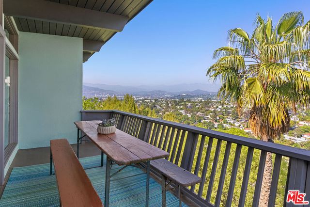 a view of a balcony with a table & chairs