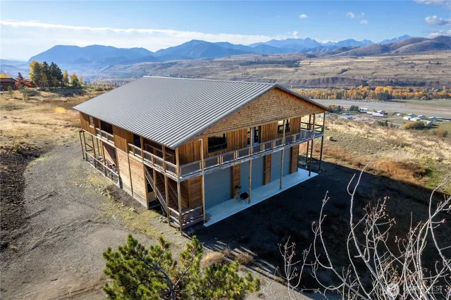 a view of a terrace with wooden floor and mountains in the background