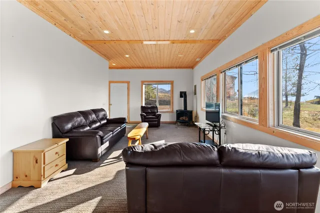 a bathroom with a granite countertop sink toilet a mirror and shower