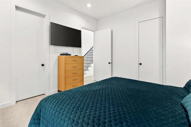 a bedroom with a bed and flat screen tv