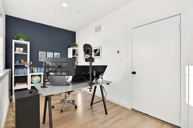a work room with furniture and wooden floor