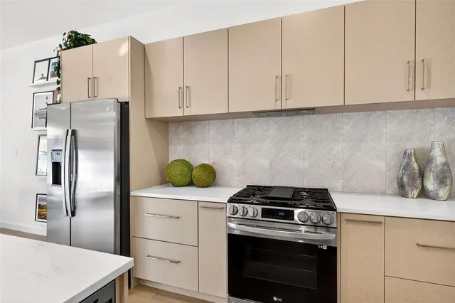 a kitchen with appliances cabinets and a counter top space