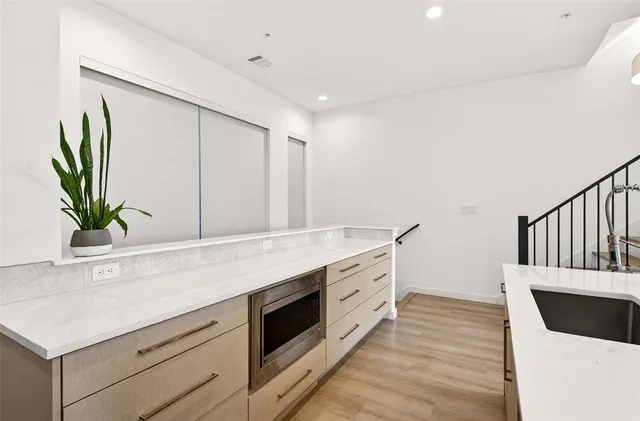 a kitchen with sink and cabinets