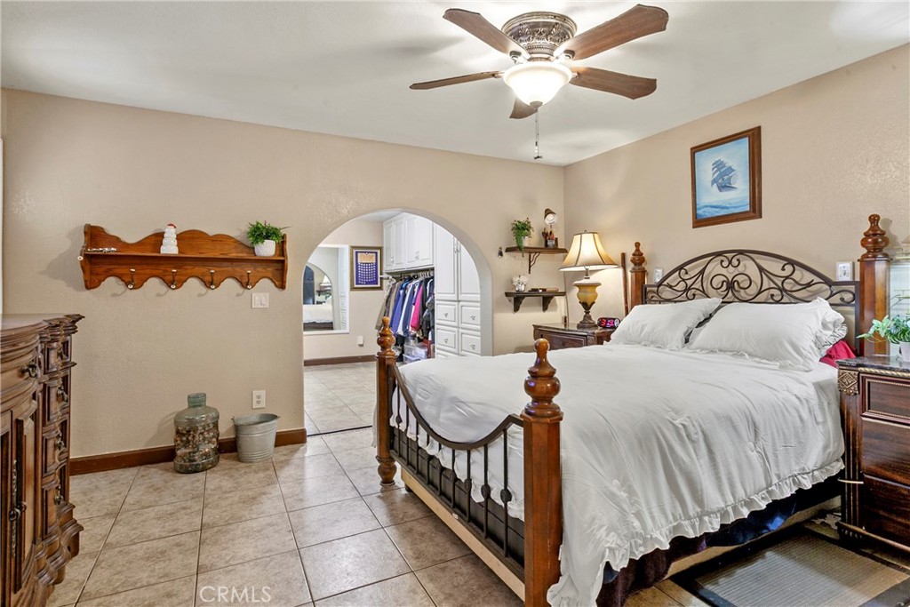245 Walnut Street Arroyo Grande, CA 93420 - Photo 14 of 34 a bed room with a bed and a chandelier