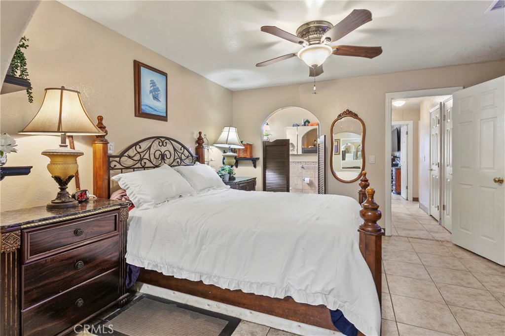 245 Walnut Street Arroyo Grande, CA 93420 - Photo 16 of 34 a bed room with a bed and a chandelier