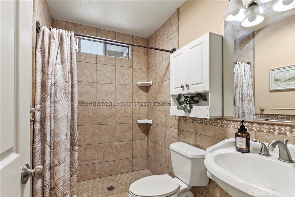 245 Walnut Street Arroyo Grande, CA 93420 - Photo 18 of 34 a bathroom with a sink toilet and shower