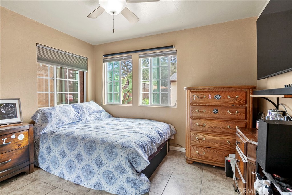 245 Walnut Street Arroyo Grande, CA 93420 - Photo 19 of 34 a bedroom with a bed and a flat tv screen on dresser