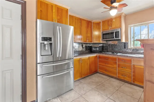 a kitchen with granite countertop stainless steel appliances and wooden cabinets