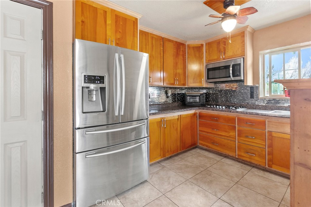 245 Walnut Street Arroyo Grande, CA 93420 - Photo 28 of 34 a kitchen with granite countertop stainless steel appliances and wooden cabinets
