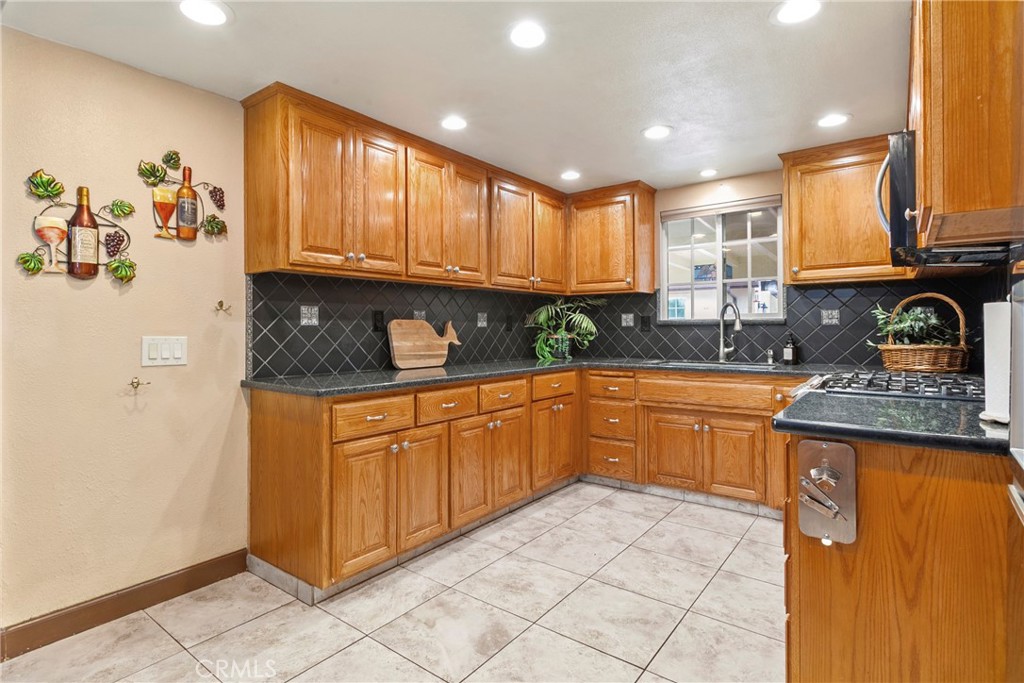 245 Walnut Street Arroyo Grande, CA 93420 - Photo 7 of 34 a kitchen with stainless steel appliances granite countertop a stove sink and cabinets