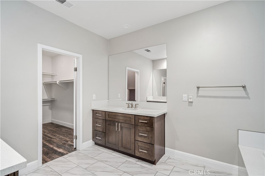 41908 Sonoma Road Palmdale, CA 93551 - Photo 26 of 75 a spacious bathroom with a granite countertop sink mirror and toilet