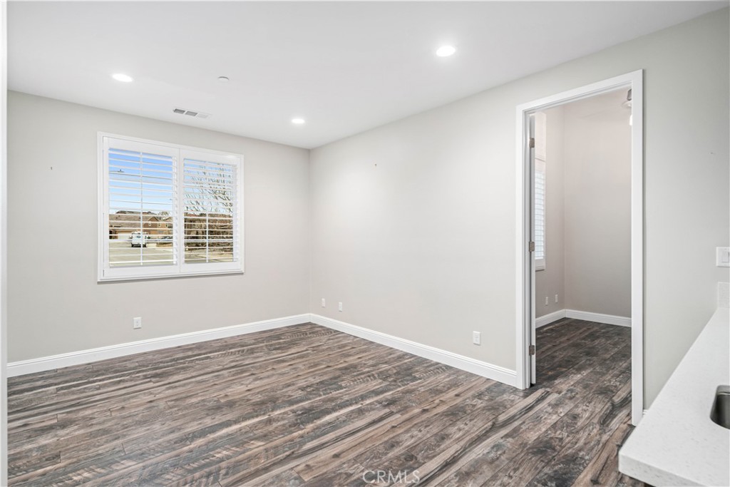 41908 Sonoma Road Palmdale, CA 93551 - Photo 33 of 75 a view of an empty room with wooden floor and a window