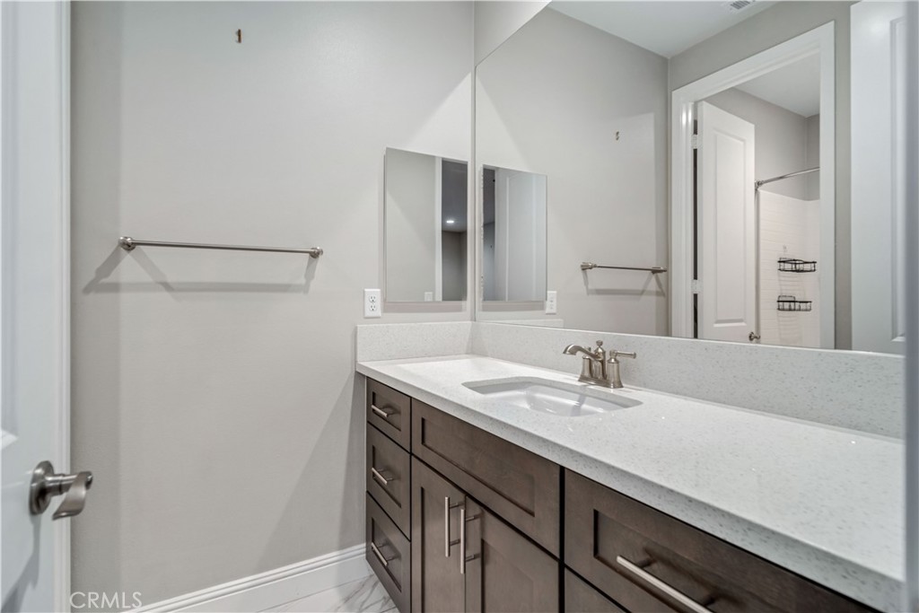 41908 Sonoma Road Palmdale, CA 93551 - Photo 37 of 75 a bathroom with a sink and a mirror
