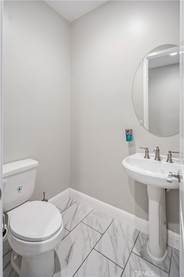 41908 Sonoma Road Palmdale, CA 93551 - Photo 41 of 75 a bathroom with a sink a toilet and mirror