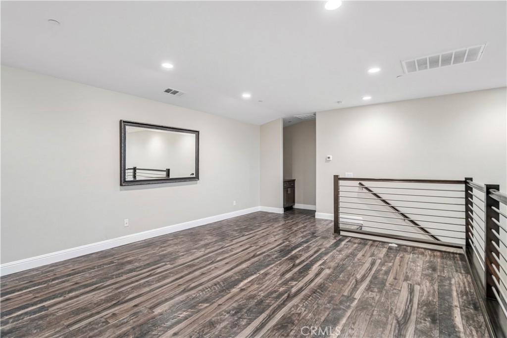 41908 Sonoma Road Palmdale, CA 93551 - Photo 44 of 75 a view of an empty room with wooden floor and stairs
