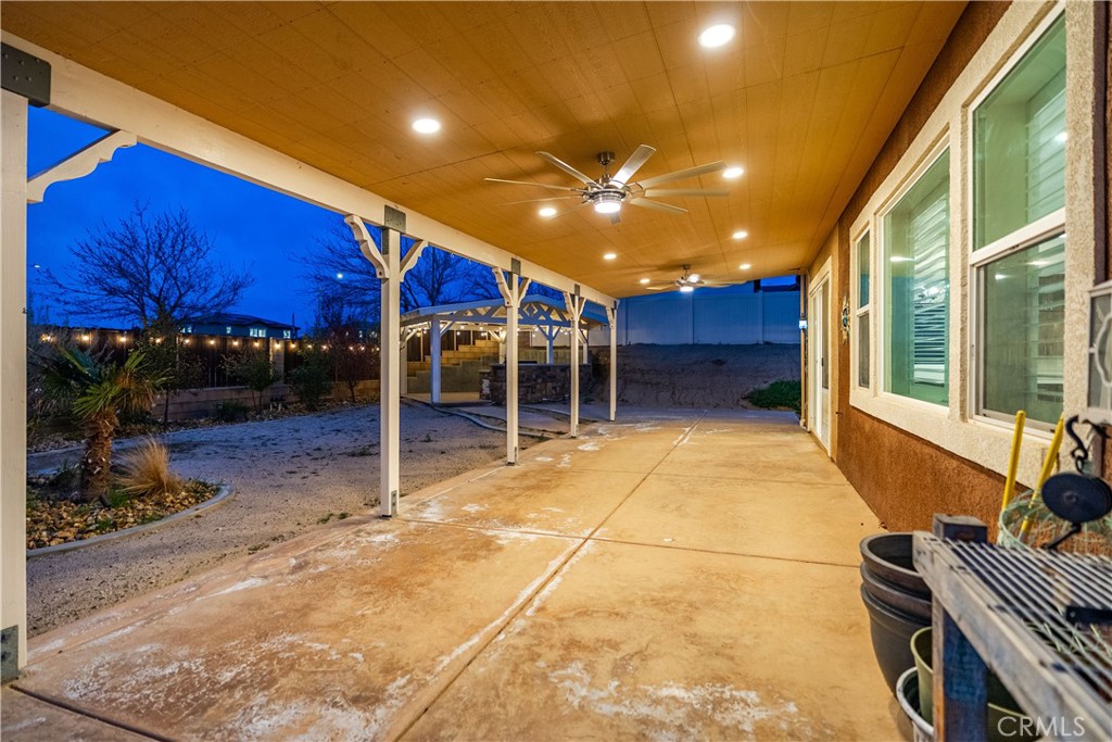 41908 Sonoma Road Palmdale, CA 93551 - Photo 53 of 75 a view of a patio with table and chairs a barbeque grill with wooden fence