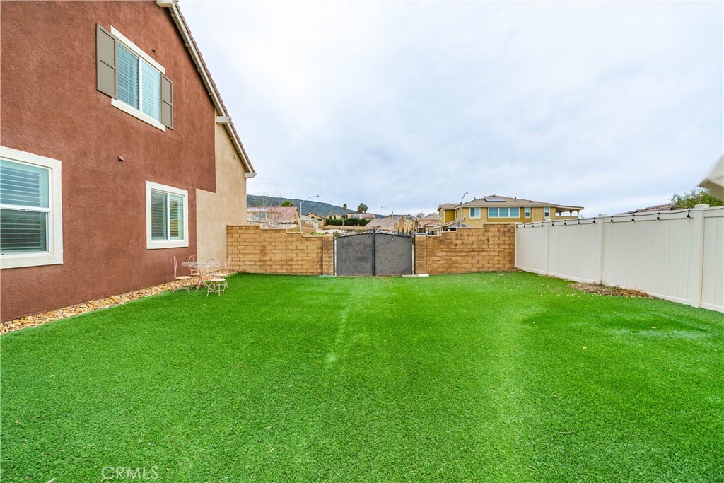 41908 Sonoma Road Palmdale, CA 93551 - Photo 68 of 75 a view of a backyard with plants and a garden