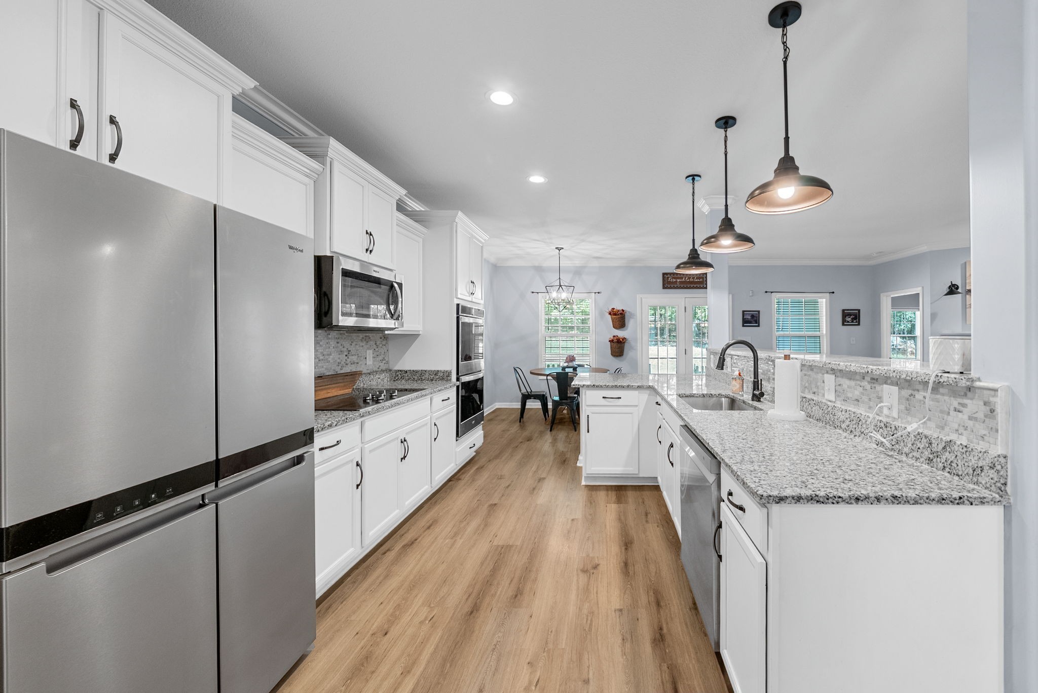 1663 Southside Road Southside, TN 37171 - Photo 19 of 59 a kitchen with stainless steel appliances granite countertop a sink a stove a refrigerator and island with wooden floor