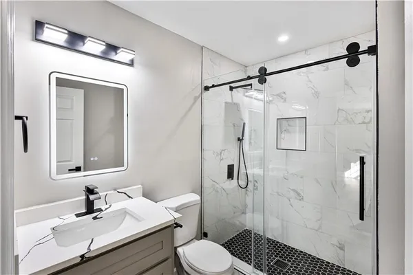 a bathroom with a sink toilet and shower