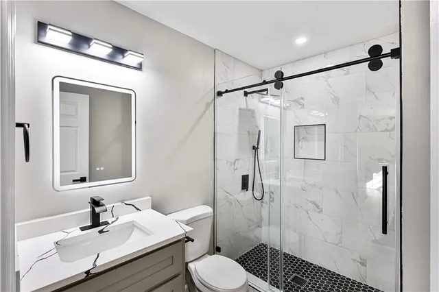 a bathroom with a sink toilet and shower