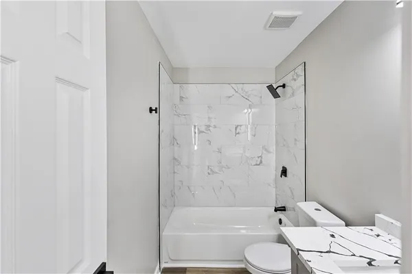 a bathroom with a toilet and a bath tub