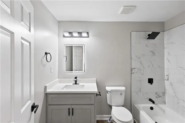 a bathroom with a sink toilet and shower