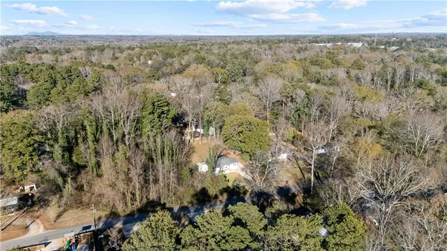 a view of a city with lush green forest