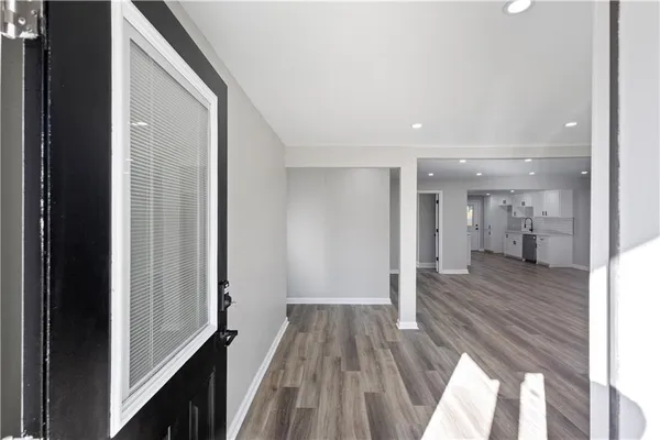 a view of a hallway with wooden floor