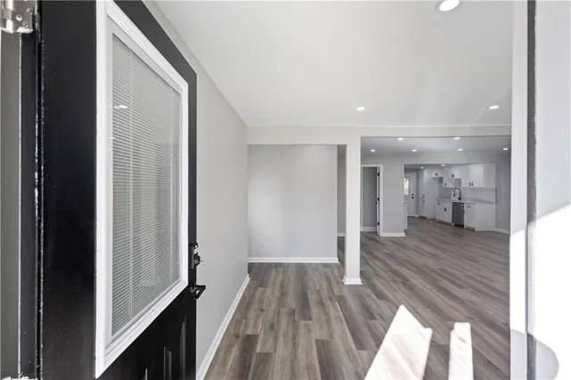 a view of a hallway with wooden floor