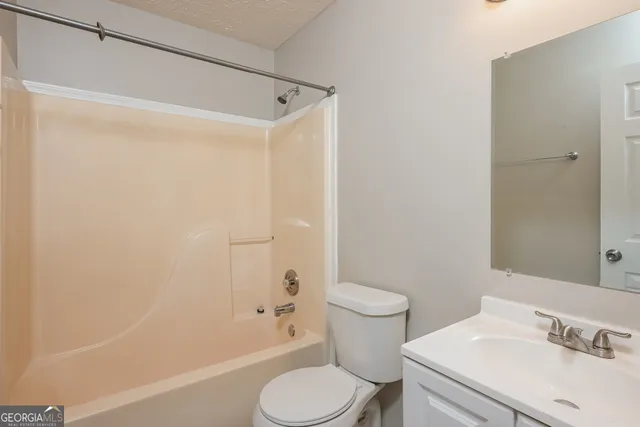 a green field with lots of trees