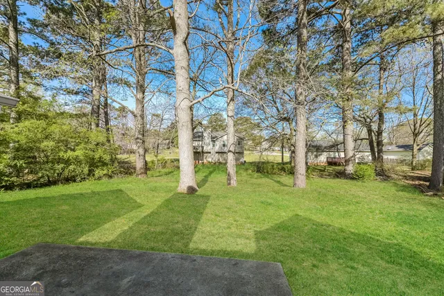 a view of a house with a yard covered in snow