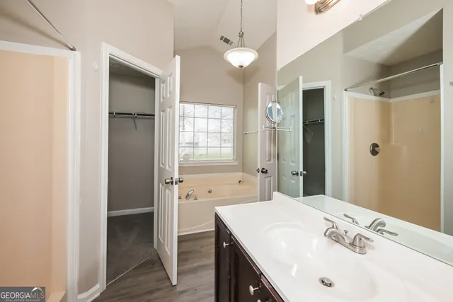 a bathroom with a sink a mirror and a shower