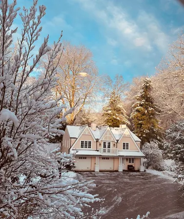 a view of a large house with a big yard and large trees
