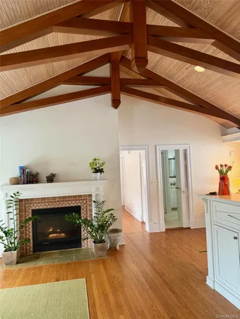 a view of a livingroom with a fireplace and wooden floor