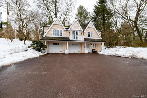 a front view of a house with a yard covered in snow