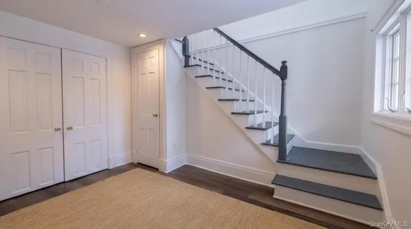 a view of entryway with stairs and wooden floor