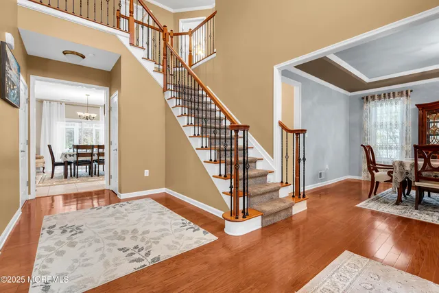 a view of entryway and hall with wooden floor