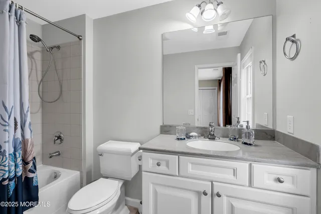 a bathroom with a sink toilet vanity and shower