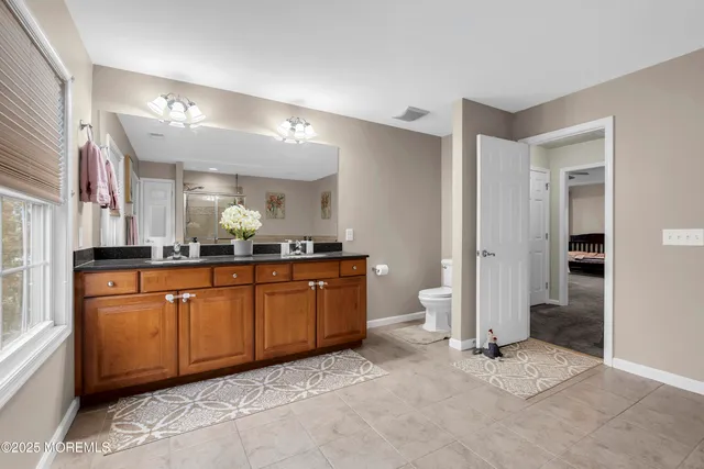 a large bathroom with a sink and a mirror