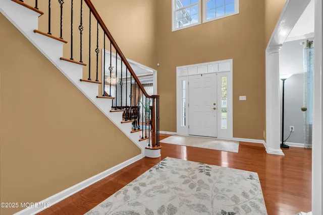a view of entryway and hall with wooden floor