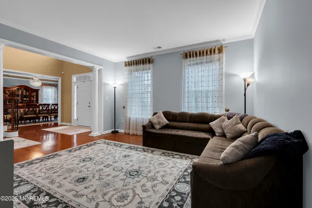 a living room with furniture and a wooden floor