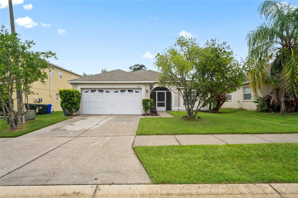 1867 Holton Road Lakeland, FL 33810 - Photo 1 of 1 a front view of a house with a yard and trees