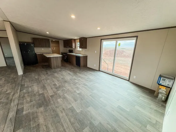 an empty room with wooden floor and entrance