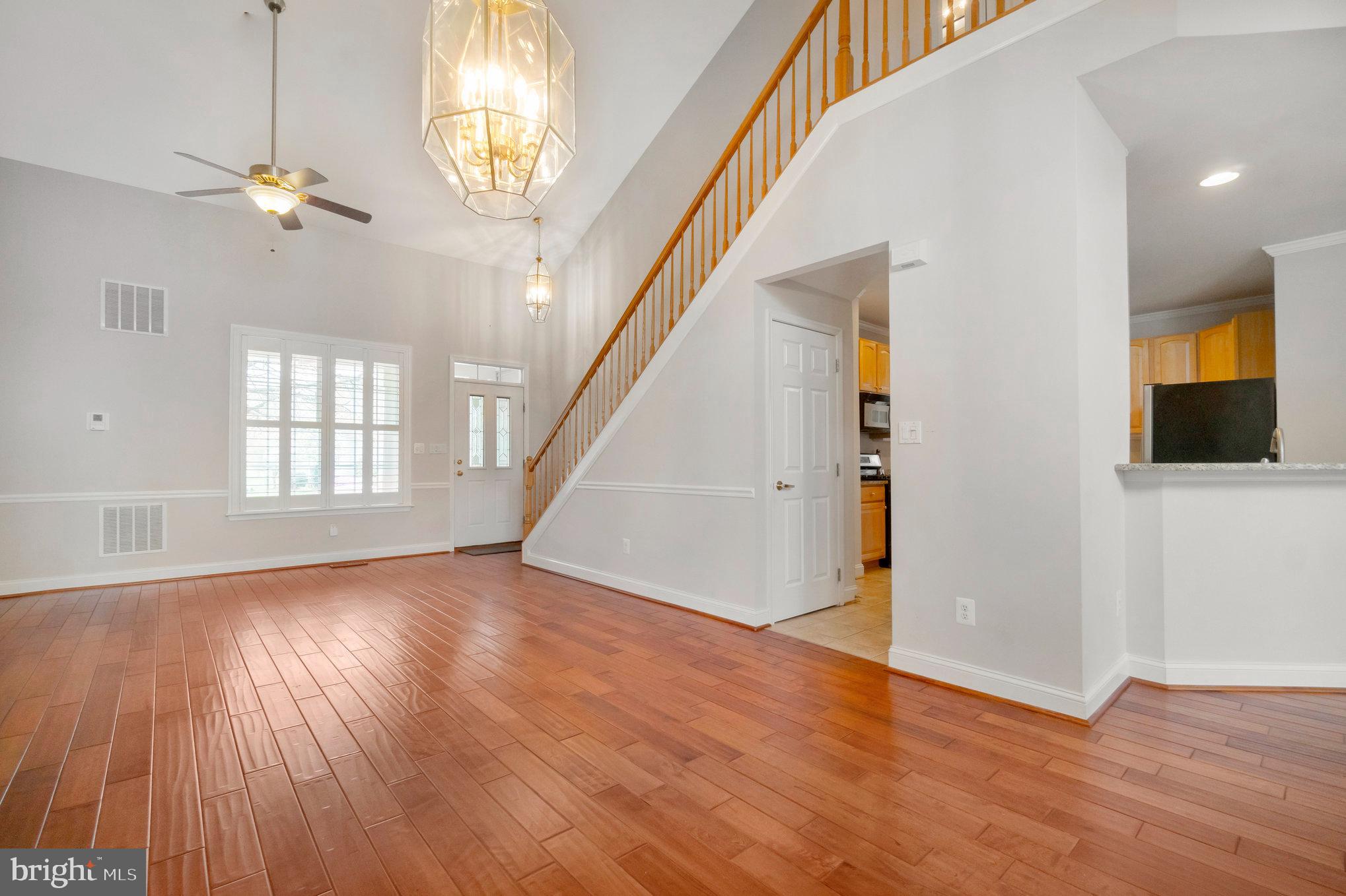 13428 Fieldstone Way Gainesville, VA 20155 - Photo 14 of 46 wooden floor in an empty room with a window