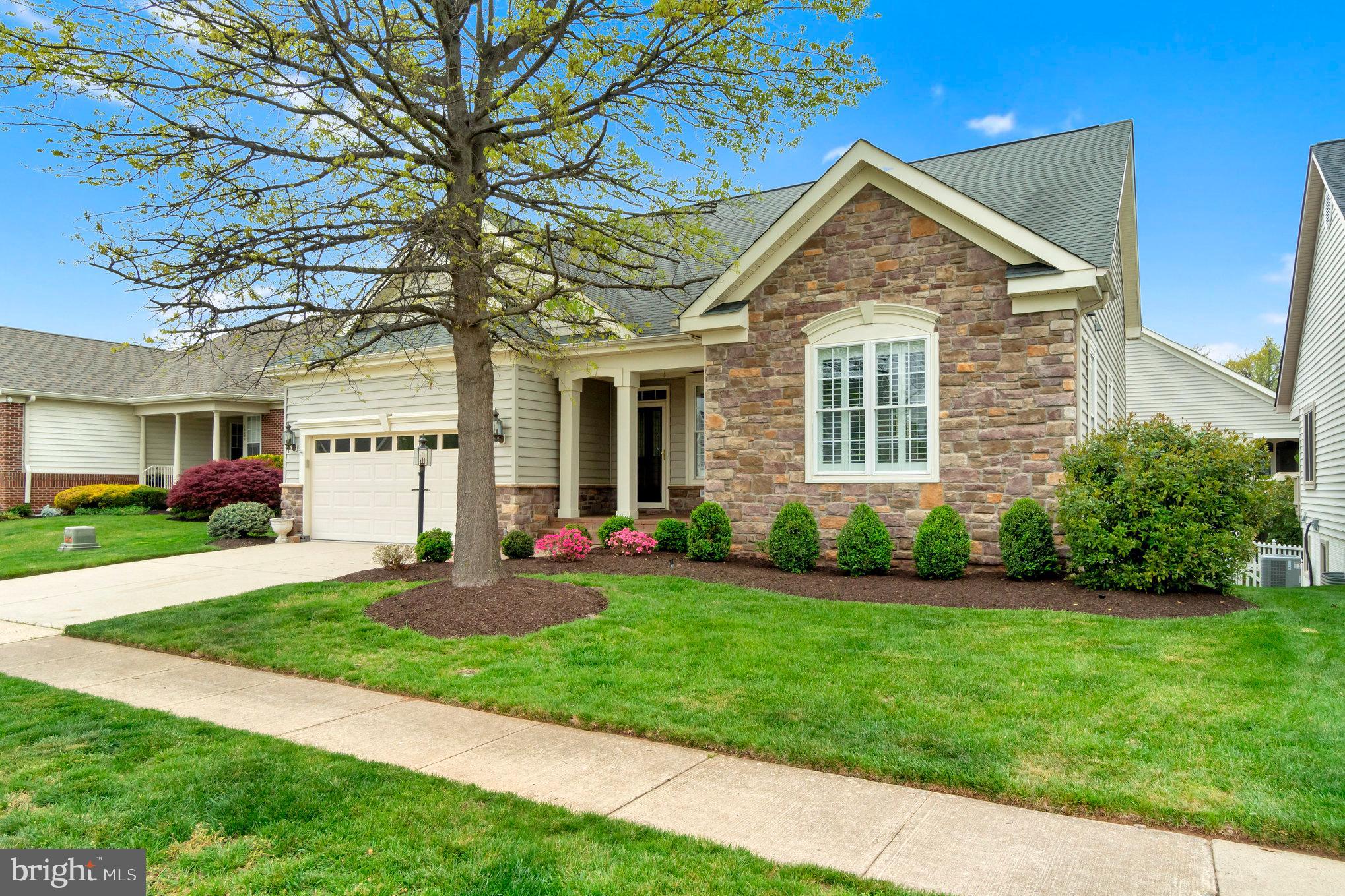 13428 Fieldstone Way Gainesville, VA 20155 - Photo 2 of 46 a front view of a house with a yard and garage