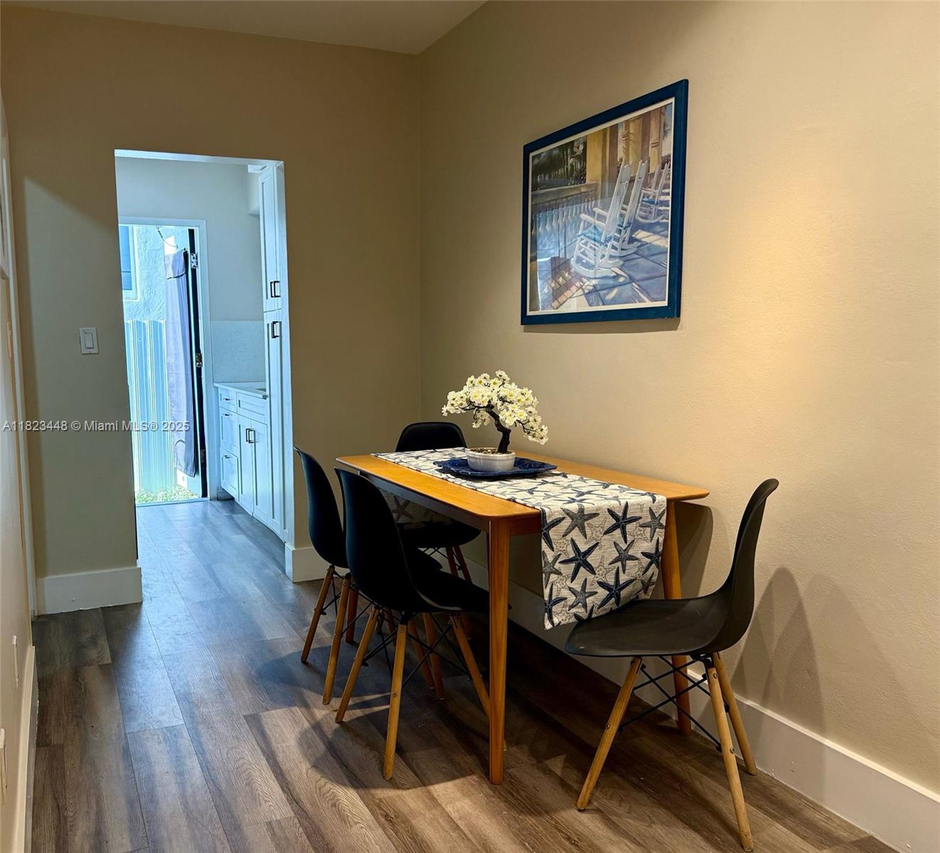 8132 Harding Avenue, Unit 2 Miami Beach, FL 33141 - Photo 13 of 20 a dining room with furniture and wooden floor