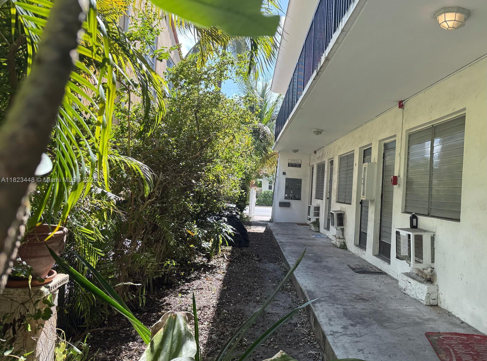 8132 Harding Avenue, Unit 2 Miami Beach, FL 33141 - Photo 18 of 20 a view of a patio with table and chairs and potted plants