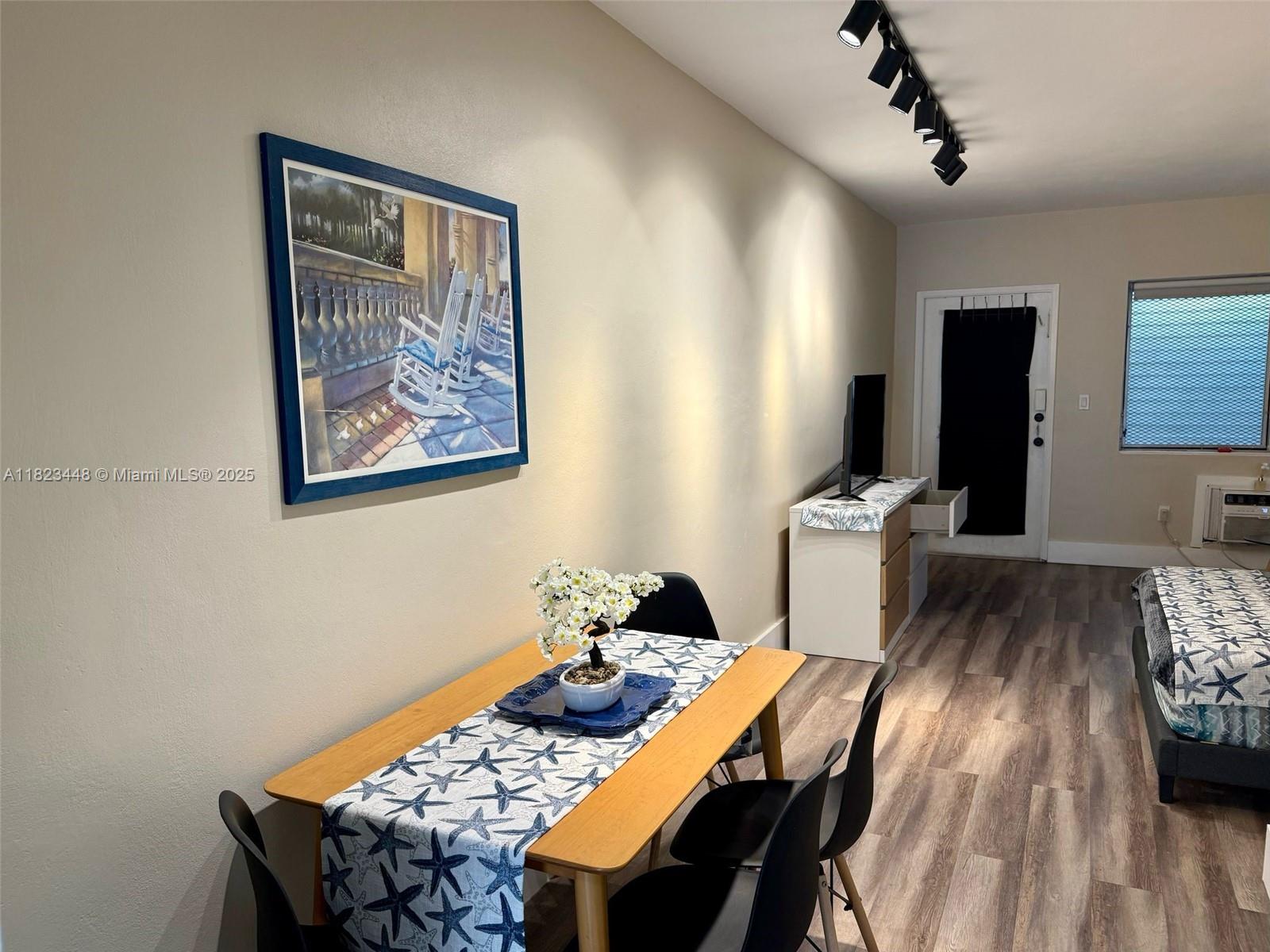 8132 Harding Avenue, Unit 2 Miami Beach, FL 33141 - Photo 5 of 20 a view of a dining room with furniture and wooden floor