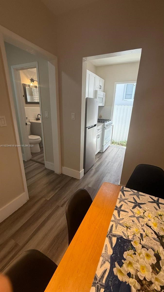 8132 Harding Avenue, Unit 2 Miami Beach, FL 33141 - Photo 8 of 20 a bedroom with a bed and wooden floor