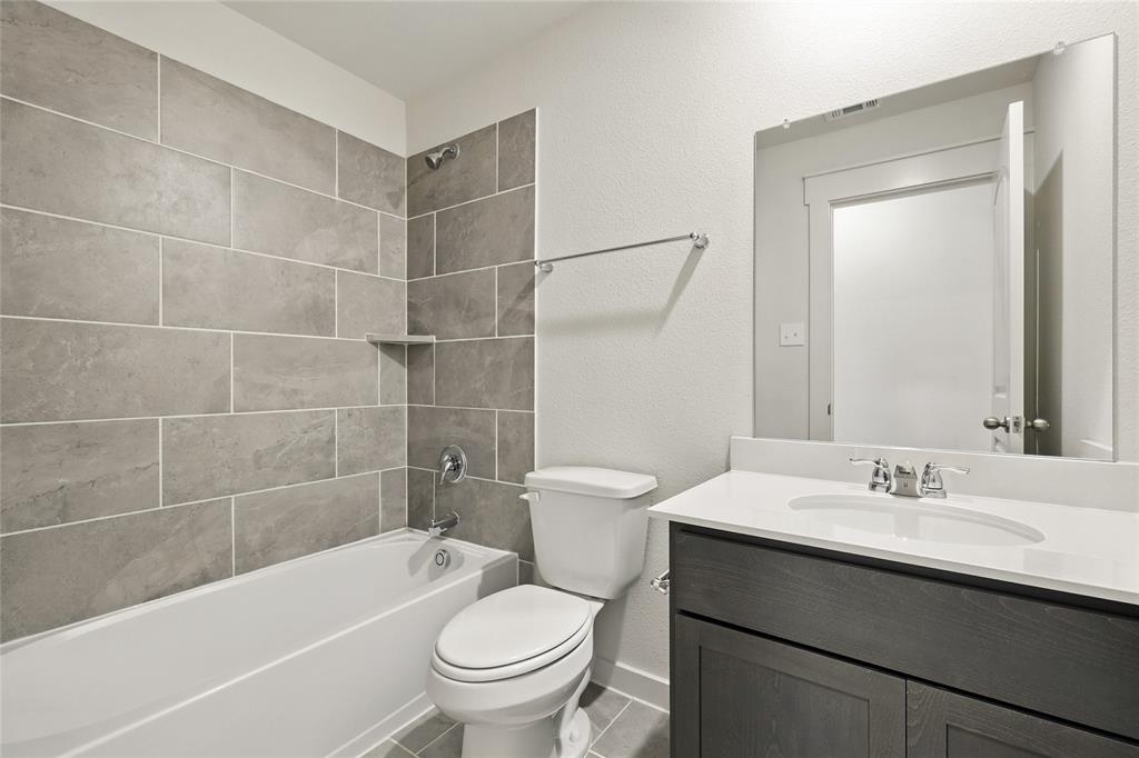 1795 Gleasondale Place Forney, TX 75126 - Photo 24 of 29 Full bath featuring a textured wall, vanity, tub / shower combination, and tile patterned flooring
